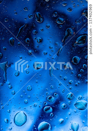 Deep blue aesthetic background with heavy water drops on dark surface Deep blue aesthetic background with heavy water drops on dark surface 137402969