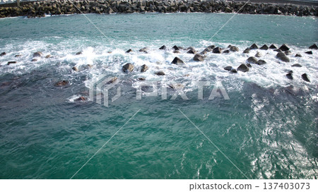 A breakwater found along the coast of Toyama Bay that is likely to be submerged due to erosion by the waves 137403073