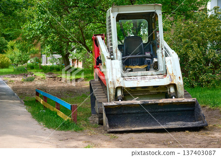 Construction bulldozer tractor with rubber tracks during excavation work Construction bulldozer tractor with rubber tracks during excavation work 137403087