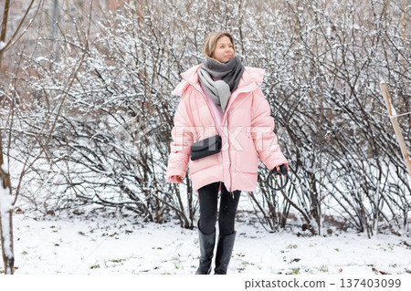 Woman enjoying music with headphones outdoors in winter Woman enjoying music with headphones outdoors in winter 137403099