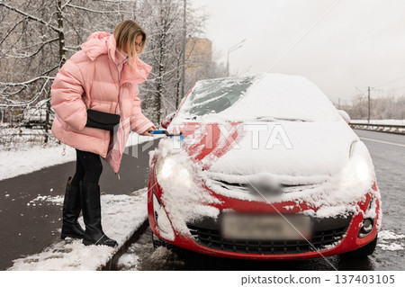 Winter car snow cleaning in city Winter car snow cleaning in city 137403105