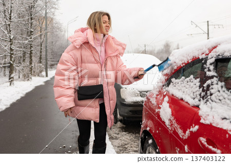 Winter car snow cleaning in city Winter car snow cleaning in city 137403122
