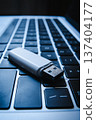 USB flash drive lying on a laptop keyboard as a concept of cyber security and digital data protection 137404177