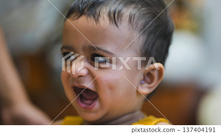 Happy little baby laughing with mouth open expressing pure joy and innocence Happy little baby laughing with mouth open expressing pure joy and innocence 137404191