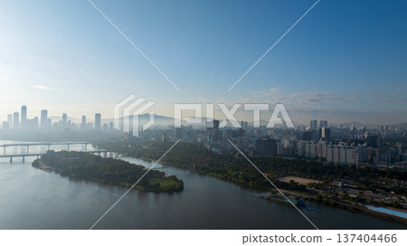 Aerial cinematic sunrise over Seonyudo Park and Hangang River with Yeouido skyline, Seoul. Aerial cinematic sunrise over Seonyudo Park and Hangang River with Yeouido skyline, Seoul. 137404466