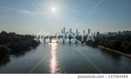 Aerial cinematic sunrise over Seonyudo Park and Hangang River with Yeouido skyline, Seoul. Aerial cinematic sunrise over Seonyudo Park and Hangang River with Yeouido skyline, Seoul. 137404469