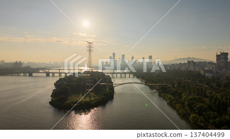 Aerial cinematic sunrise over Seonyudo Park and Hangang River with Yeouido skyline, Seoul. Aerial cinematic sunrise over Seonyudo Park and Hangang River with Yeouido skyline, Seoul. 137404499