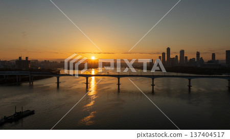 Aerial cinematic sunrise over Seonyudo Park and Hangang River with Yeouido skyline, Seoul. Aerial cinematic sunrise over Seonyudo Park and Hangang River with Yeouido skyline, Seoul. 137404517