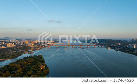 Aerial cinematic sunrise over Seonyudo Park and Hangang River with Yeouido skyline, Seoul. Aerial cinematic sunrise over Seonyudo Park and Hangang River with Yeouido skyline, Seoul. 137404520