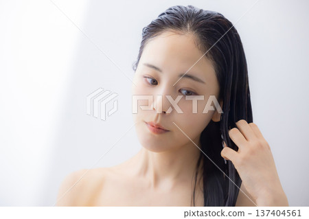 Woman doing hair treatment Woman doing hair treatment 137404561