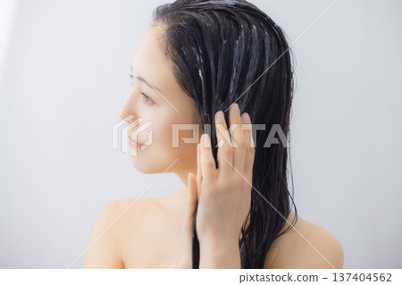 Woman doing hair treatment Woman doing hair treatment 137404562