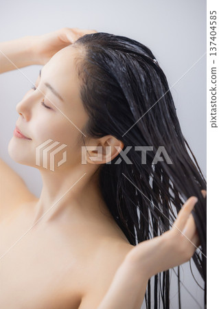 Woman doing hair treatment Woman doing hair treatment 137404585