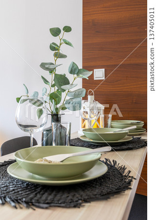 modern dining table setting with eucalyptus 137405011