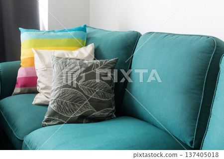 Cozy teal sofa with pillows Cozy teal sofa with pillows 137405018