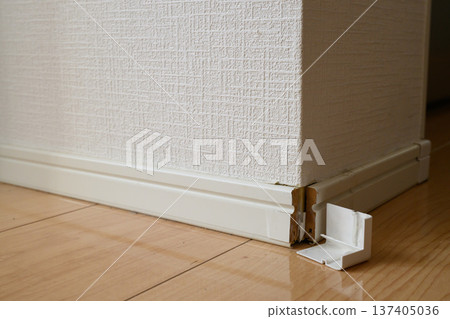 Damaged baseboard in the corner of the room and missing corner cap Damaged baseboard in the corner of the room and missing corner cap 137405036