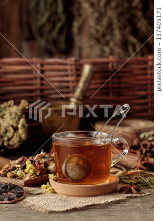 Cup of herbal tea with various dried herbs, flowers, and spices. Cup of herbal tea with various dried herbs, flowers, and spices. 137405171
