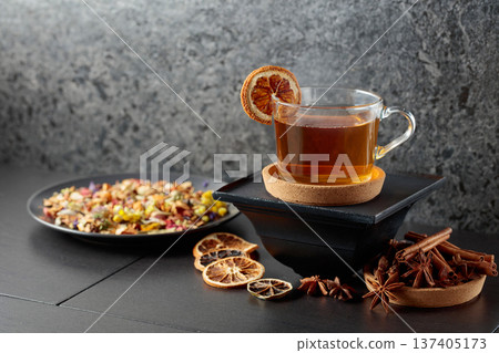 Cup of herbal tea with ingredients and slices of dried orange slices. Cup of herbal tea with ingredients and slices of dried orange slices. 137405173