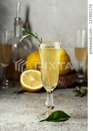 Italian liqueur Limoncello with fresh lemons and rosemary branches. Italian liqueur Limoncello with fresh lemons and rosemary branches. 137405178