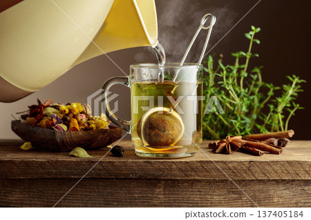 Herbal tea with ingredients on a old wooden table. 137405184