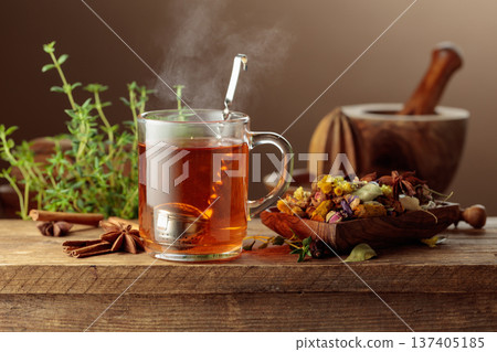 Herbal tea with ingredients on a old wooden table. 137405185