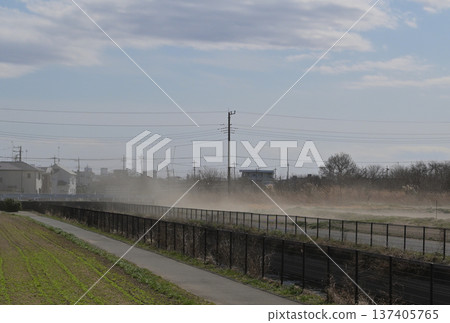 Spring, rural residential area, dust flying in the fields 137405765