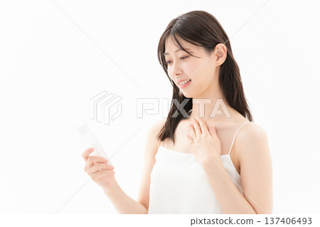 Beauty image of a woman doing skin care on a white background 137406493