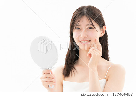 Beauty image of a woman doing skin care on a white background 137406498