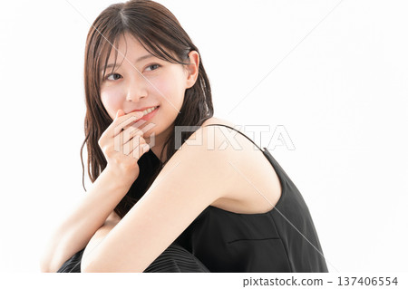 Beauty image of a woman doing skin care on a white background 137406554