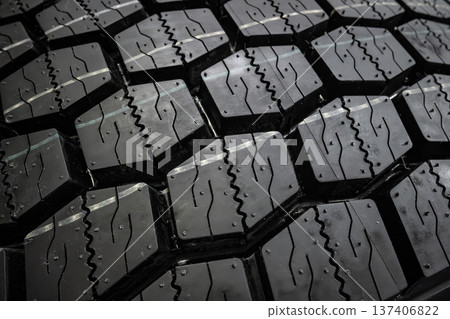 Black tire tread texture background with detailed rubber pattern. 137406822