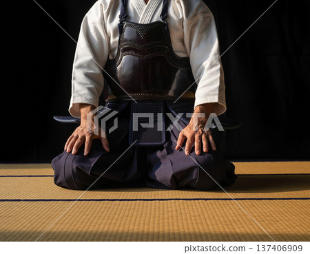 A person sitting in seiza position wearing a karate uniform 137406909
