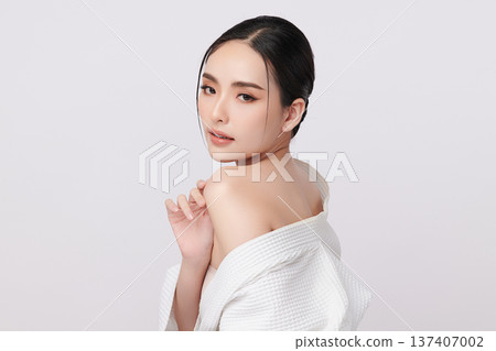 A beautiful young Asian woman with clean, fresh skin against a white background. Skincare, facial treatment, cosmetology, beauty, and spa. An elegant portrait of an Asian woman. A beautiful young Asian woman with clean, fresh skin against a white background. Skincare, facial treatment, cosmetology, beauty, and spa. An elegant portrait of an Asian woman. 137407002