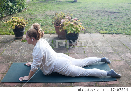 Mature Woman Practicing Yoga at Home Mature Woman Practicing Yoga at Home 137407234