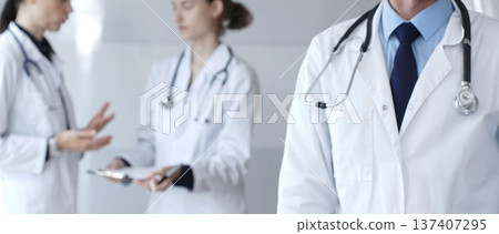 Doctor giving thumbs up sign for medical approval while standing with health practitioners, symbolizing trust in healthcare, patient well being, and successful treatment Doctor giving thumbs up sign for medical approval while standing with health practitioners, symbolizing trust in healthcare, patient well being, and successful treatment 137407295