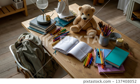A teddy bear sitting on top of a wooden table next to a pile of books A teddy bear sitting on top of a wooden table next to a pile of books 137408052