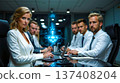 A group of business people sitting around a conference table with laptops 137408204