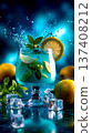 A glass of blue drink with lemon slices and mint leaves 137408212