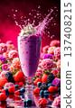 A glass of fruit smoothie with whipped cream and berries on a table 137408215
