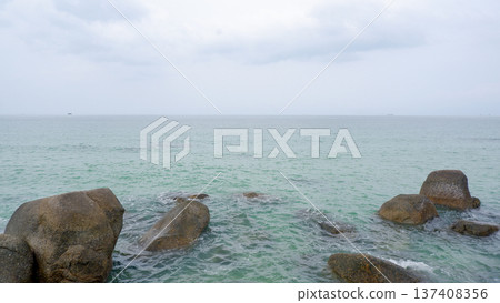 Calm Tropical Sea With Granite Rocks Under Cloudy Sky Calm Tropical Sea With Granite Rocks Under Cloudy Sky 137408356