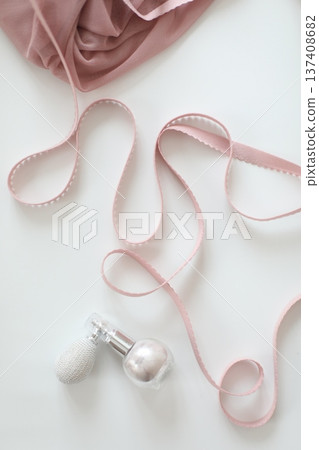Top view of pink cosmetics, powder with ribbons on a white background. Minimalist feminine flat lay with copy space for Valentine's Day, Birthday or Mother's Day. High quality photo Top view of pink cosmetics, powder with ribbons on a white background. Minimalist feminine flat lay with copy space for Valentine's Day, Birthday or Mother's Day. High quality photo 137408682