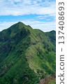Mountain ridge hiking trail under blue sky in tropical forest. 137408693