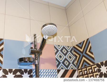 Shower set with running water, featuring a hand shower and a riser rail. 137408756