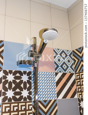 Shower set with running water, featuring a hand shower and a riser rail. 137408757