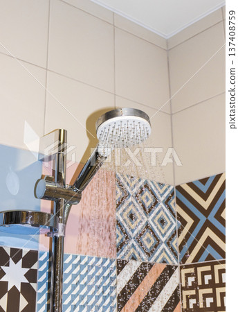 Shower set with running water, featuring a hand shower and a riser rail. 137408759