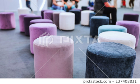 Colorful velvet poufs arranging an informal seating area for an modern interior event 137408831