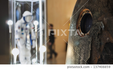 Soyuz spacecraft capsule and spacesuit on display depicting space history and exploration Soyuz spacecraft capsule and spacesuit on display depicting space history and exploration 137408859