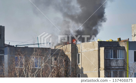 Building fire emergency with black smoke billowing from residential apartment block roof Building fire emergency with black smoke billowing from residential apartment block roof 137408875