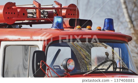 Flashing blue lights and orange signal lamps mounted on red fire truck roof 137408881