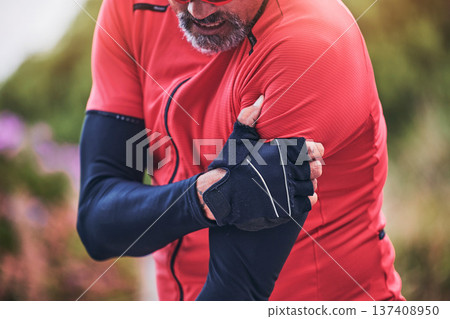 Man, cyclist and arm injury in sports accident, emergency or broken bone on mountain road in nature. Closeup of male person or athlete with sore pain, ache or joint inflammation from cycling or fall 137408950