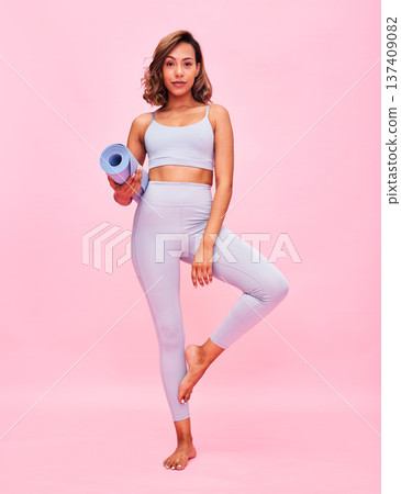 Yoga, portrait and woman with mat in studio for healthy body, fitness or focus on pink background. Sports model in tree pose for pilates training, holistic workout or balance for exercise performance 137409082
