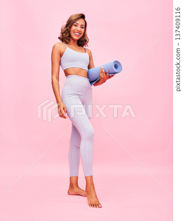 Fitness, portrait and woman with yoga mat on pink background for healthy body, exercise and smile in studio. Happy young sports model ready for pilates training, workout or performance to lose weight Fitness, portrait and woman with yoga mat on pink background for healthy body, exercise and smile in studio. Happy young sports model ready for pilates training, workout or performance to lose weight 137409116